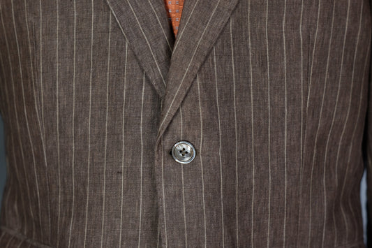 Close-up of a brown pinstripe suit jacket with a button.