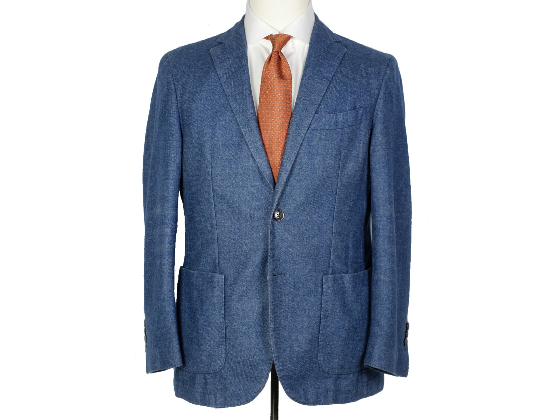Blue blazer with a white shirt and orange tie on a mannequin against a white background